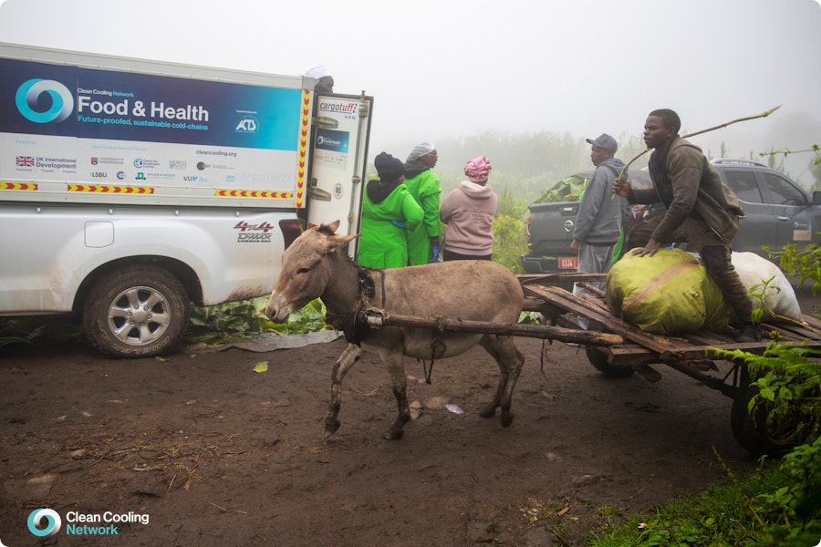 Kenya farmer and cart in contrast to the CCN truck