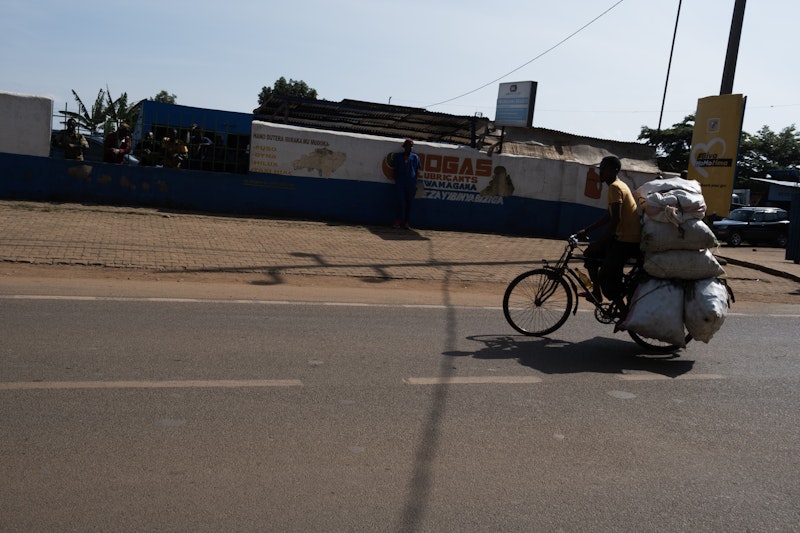 Man cycling with produce in Rwanda