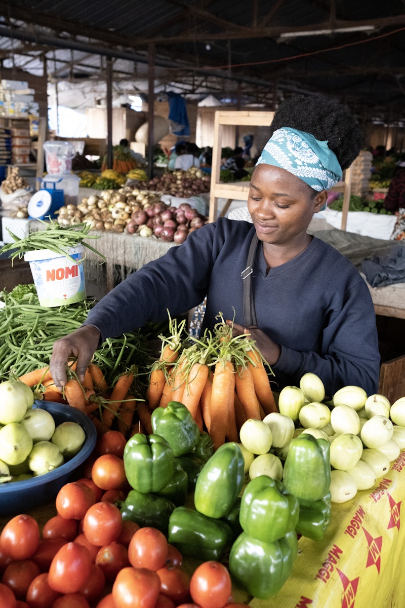 A woman selling vegetables in a market