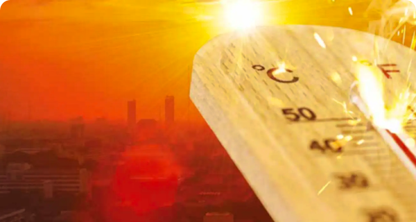 A thermometer in front of a city overheating under the hot sun