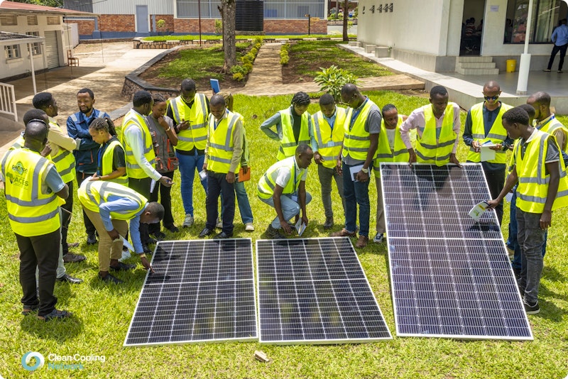 Students at ACES receiving information about the use of solar energy panels